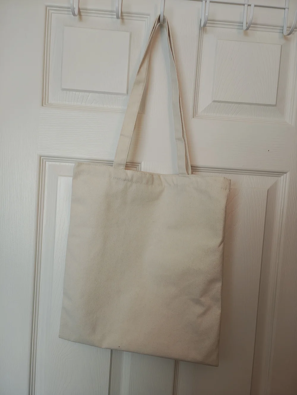 Pizza Planet Toy Story cream canvas tote bag.